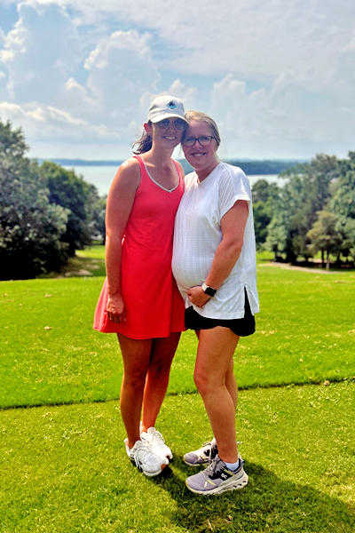 Male and female residents standing at the golf course