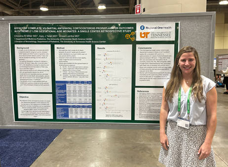 Dr. Miller standing in front of her presentation poster