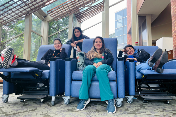 Four female residents sitting in a lounge area