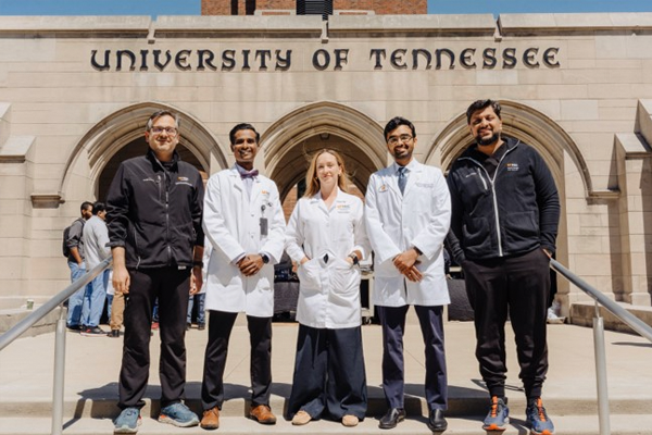 Fellows and program director in front of Univ of Tennessee arch