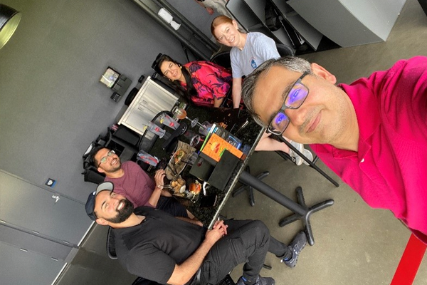 Fellows eating outdoors at Top Golf