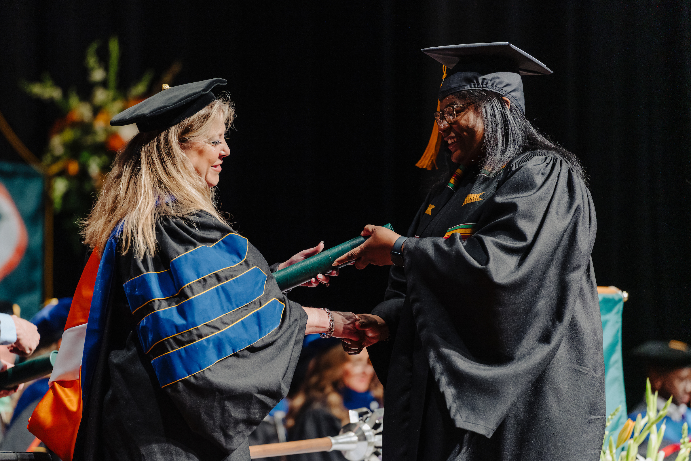 bsngrad1 Graduate receiving diploma from dean