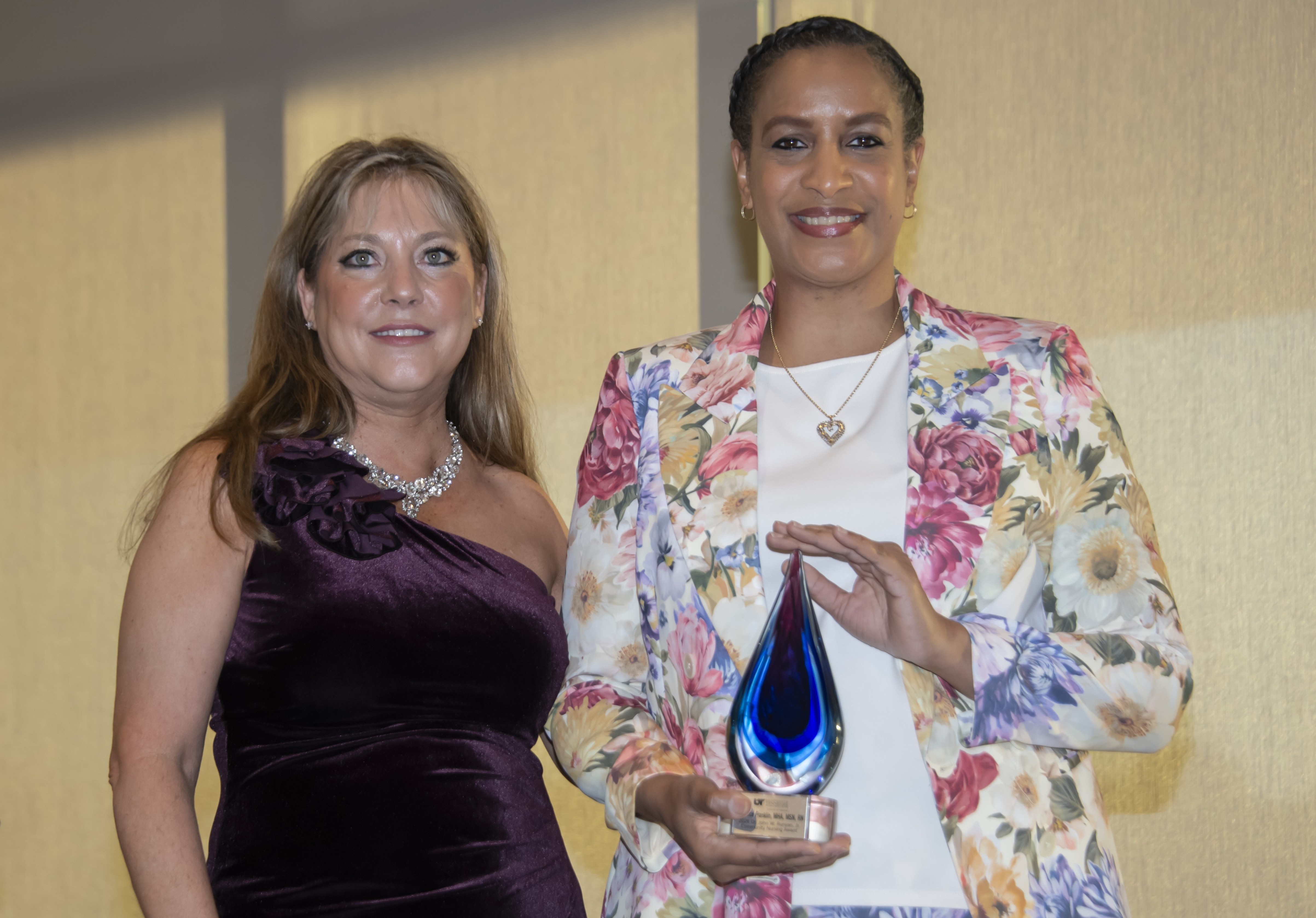 two women holding award