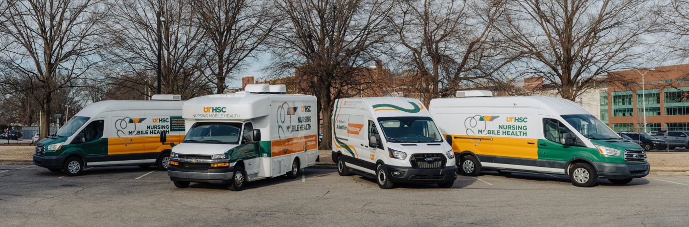four medical vans parked in front of trees
