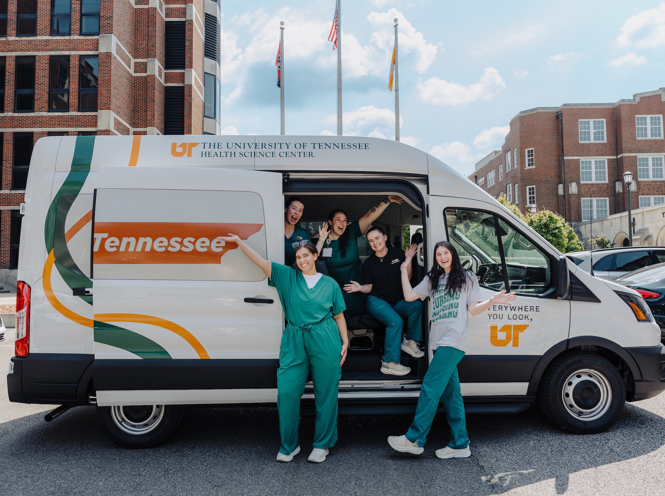 nursing students in front of van