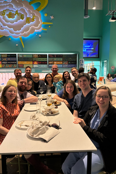 Group photo of fellows eating at a restaurant