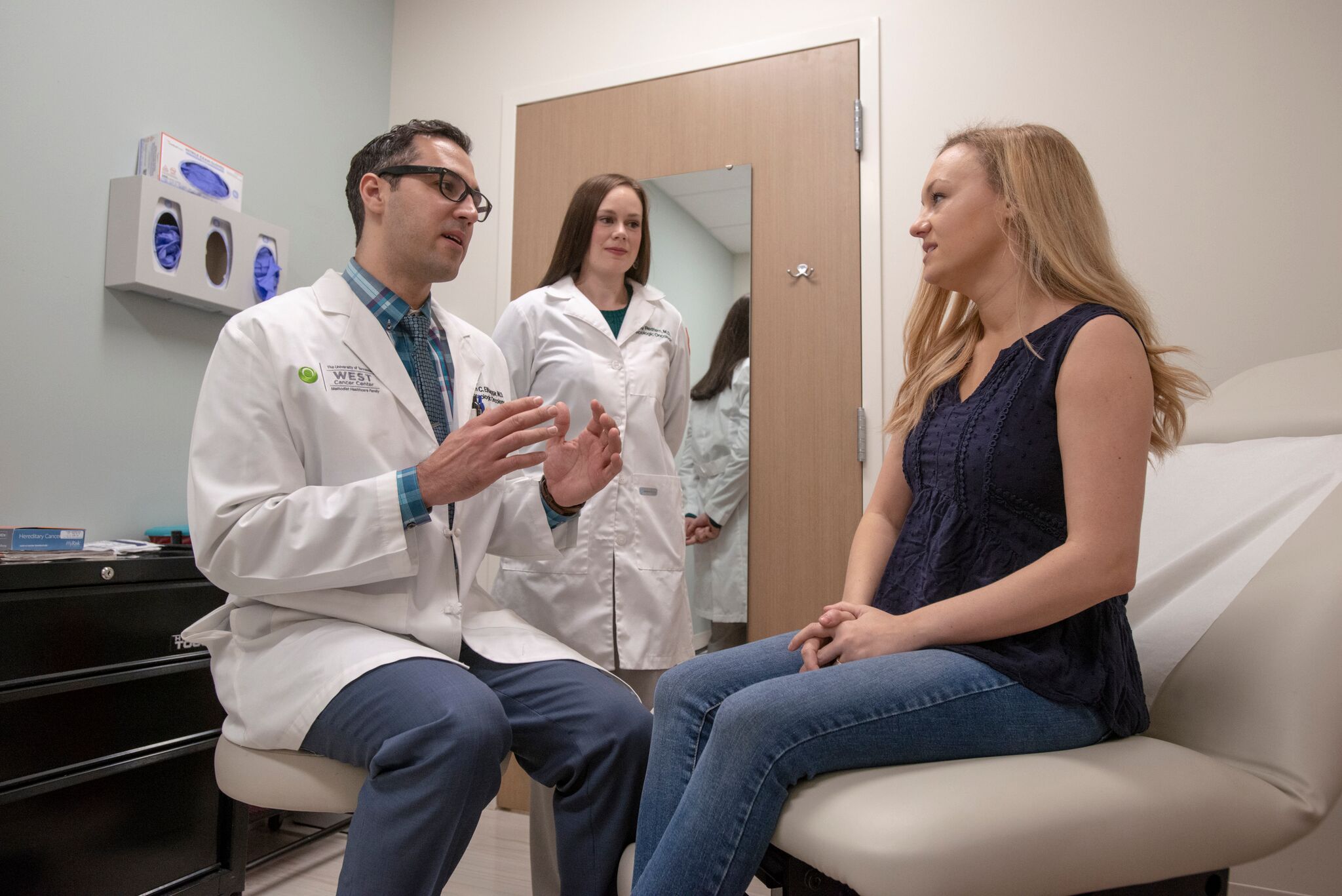 Fellows and a doctor working with a patient