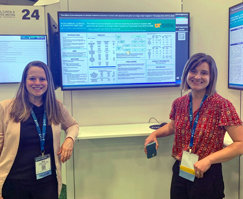 Residents in front of a presentation screen at a conference