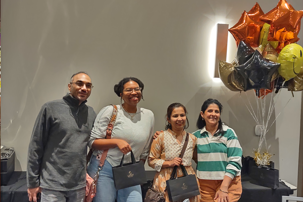 Residents/faculty standing inside near balloons