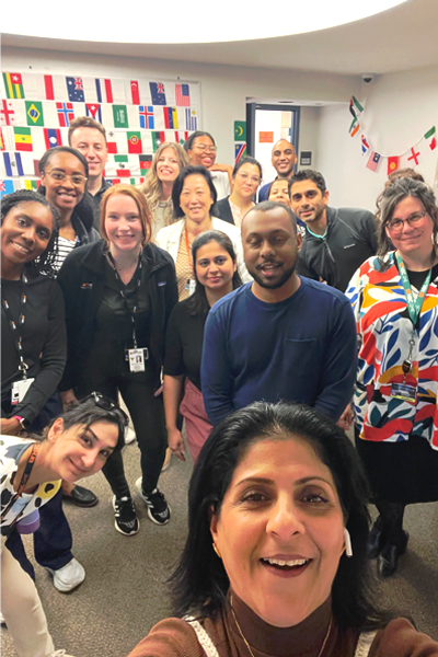Group photo in front of colored flags