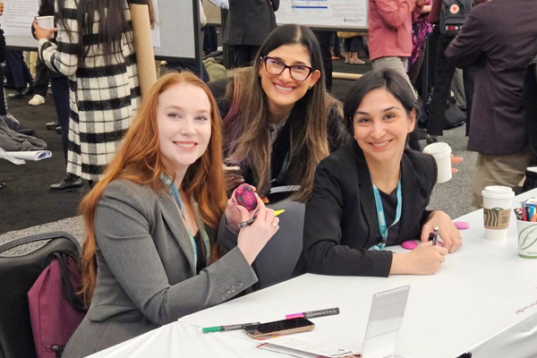 Three female residents sitting at a table