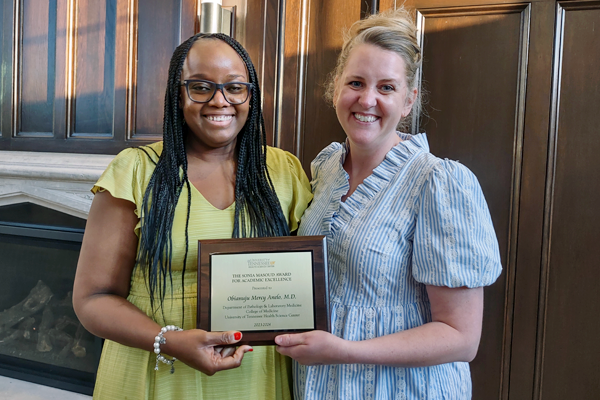 Two residents holding a certificate