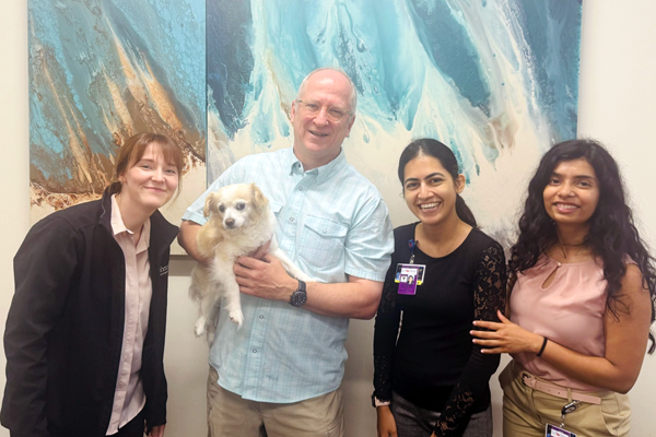 Fellows and faculty with a puppy