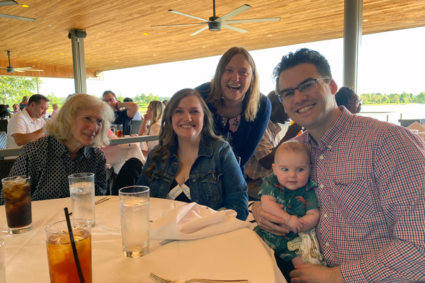 Fellow and family at graduation in an outdoor setting