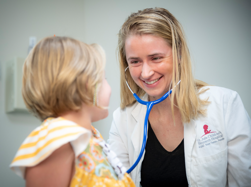 Female doctor examining a girl patient