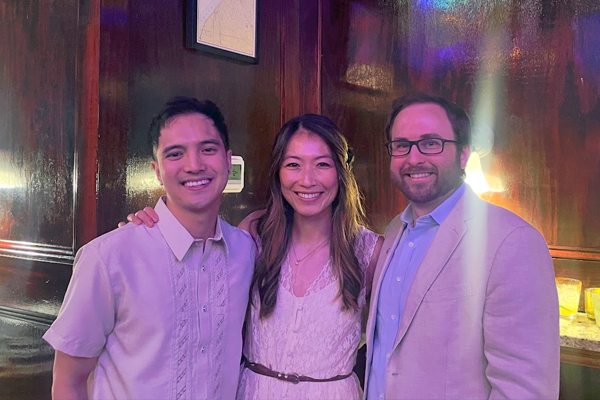 Group photo of three fellows in an indoor setting