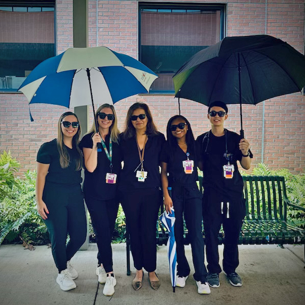Group photo with residents and program director in hospital hallway