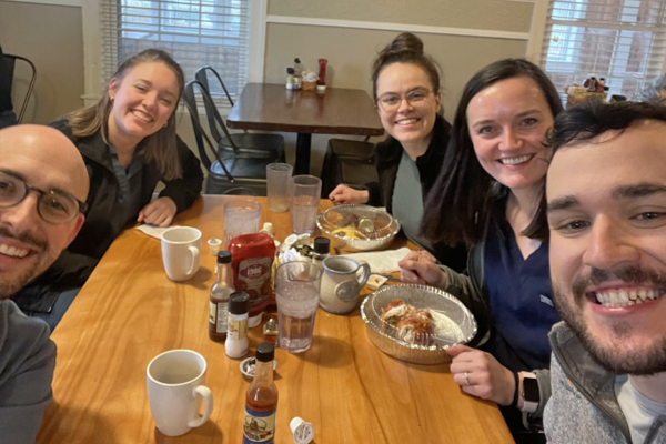 Residents sitting at a dining table taking a selfie