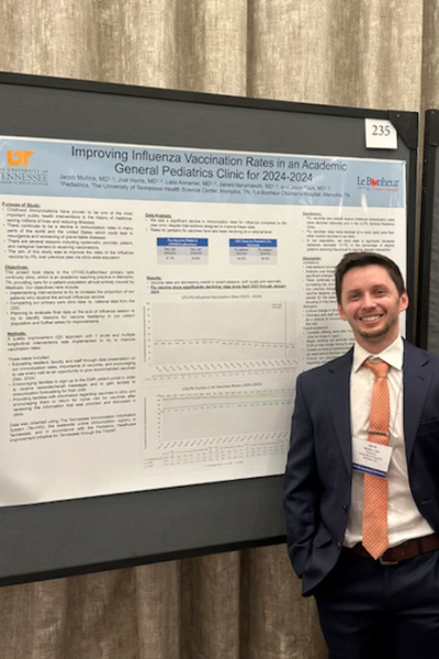 Resident standing before a poster presentation