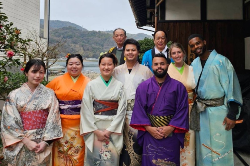 Pharmacy students walk down building stairs.