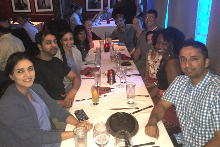 Fellows and family at a dinner table