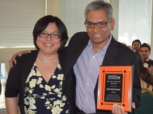 Dr. Muthiah and fellow holding an award