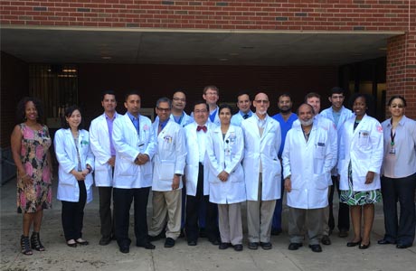 Faculty and fellows outside the Coleman Building