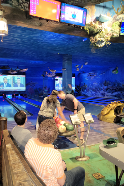 Residents bowling in the Bass Pro Shop