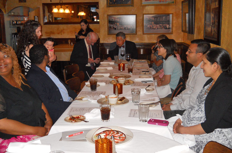 fellows and faculty at a table for graduation 2016