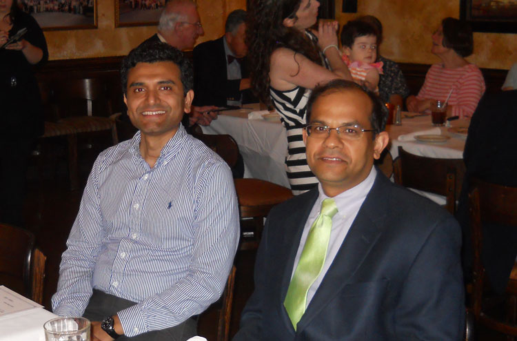 fellow and faculty smiling at the graduation