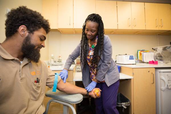 Man preparing to have his blood drawn.