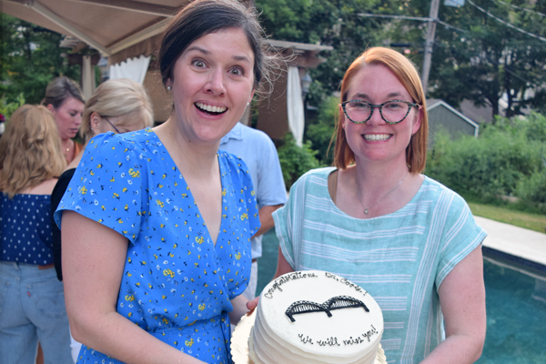 Graduates holding cake