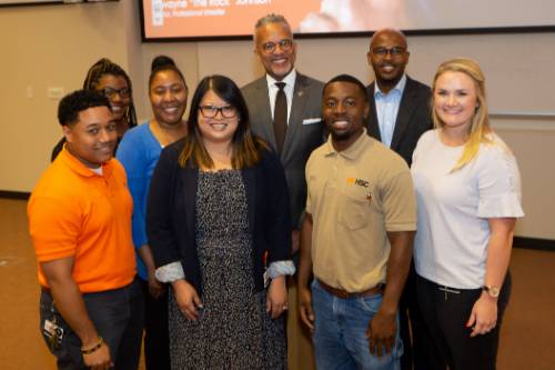 The YPG Steering Committee poses with Donald Comer after the speech.